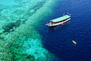 Wakatobi-dive-snorkel-boat-on-nearby-reef.-Courtesy-of-Didi-Lotze-585x389